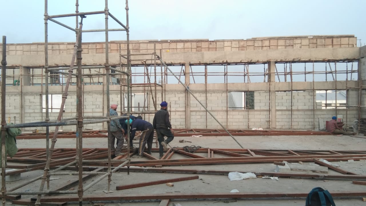 Workers and scaffolding at an Amardeep Singh building construction site
